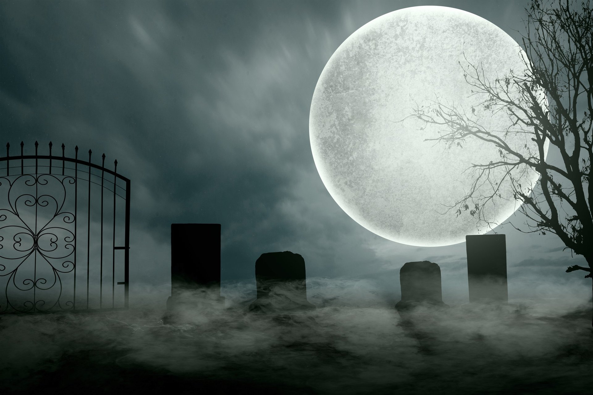 Gravestones in graveyard with full moon and dramatic fog, Halloween background